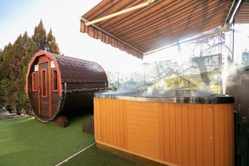 a hot tub in a yard next to a building at SPA Hotel Olymp in Velingrad
