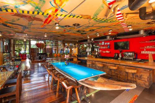a bar with a ping pong table in a restaurant at MeStyle Place Hotel in Bangkok