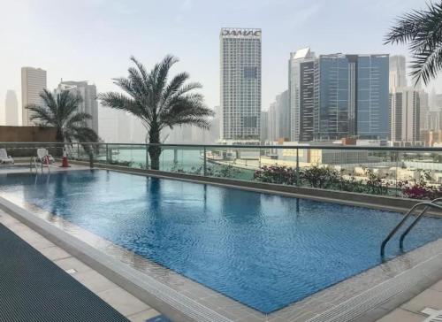 a large swimming pool on the roof of a building at Noma Fairview - Burj Khalifa view stunning apartment in Business Bay in Dubai