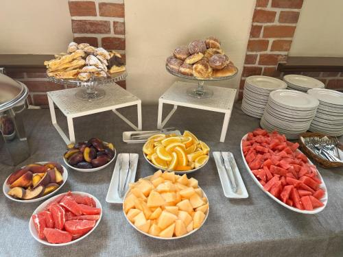 a table topped with bowls of different types of food at Hotel Młyn Aqua Spa Biblioteka in Elblag