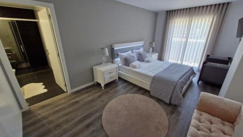 a bedroom with a bed and a room with a window at Appartement Ponte de lima in Ponte de Lima