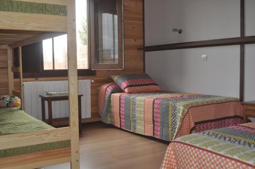 a bedroom with two bunk beds and a window at Casa Rural Mentesana in Villanueva de la Fuente