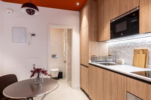 a small kitchen with a table and a sink at Estudios Arturo Soria by Rent Me in Madrid