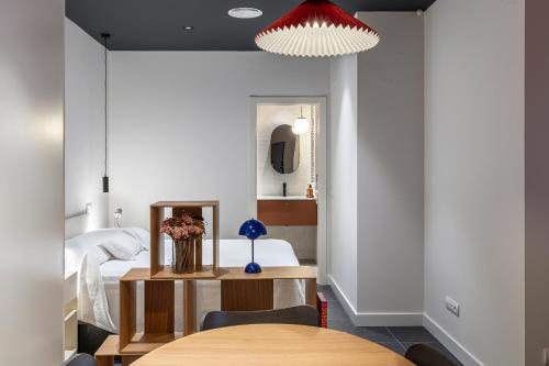 a bedroom with a bed and a table in front of it at Estudios Arturo Soria by Rent Me in Madrid