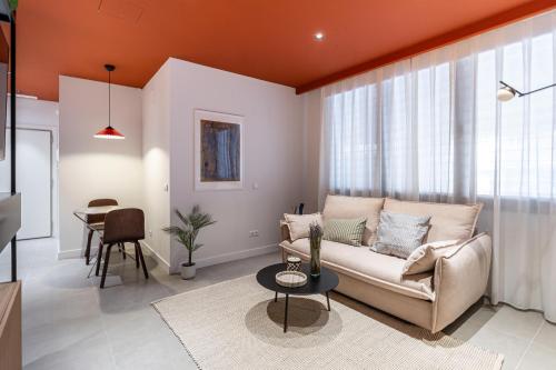 a living room with a couch and a table at Estudios Arturo Soria by Rent Me in Madrid