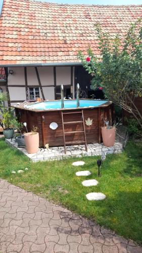 a swimming pool in the backyard of a house at Olympe in Dessenheim