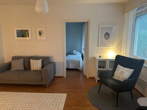 a living room with a couch and a chair at Finngland I in Rovaniemi