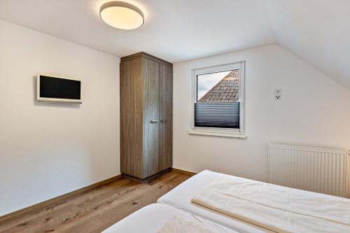 a bedroom with a bed and a window at Haus an der Haslach in Lenzkirch