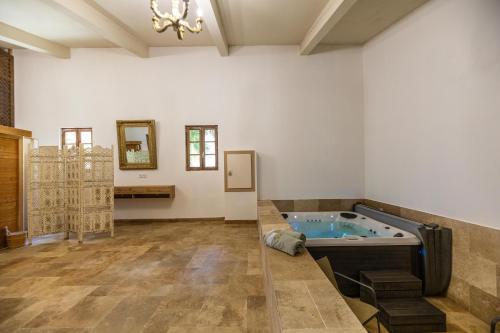a large bathroom with a tub in a room at Domaine du Reginu in Santa-Reparata-di-Balagna