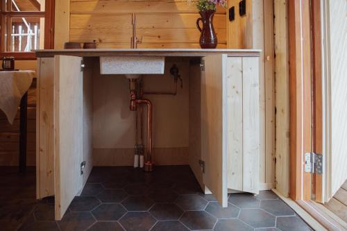 a kitchen with a counter top in a room at Forest Cabin Ainola next to Nuuksio National Park, in addition Hot Tub and Breakfast in Otalampi