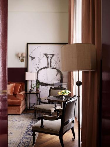 a living room with a table and two chairs at NoMad London in London