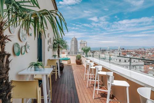 a balcony of a restaurant with tables and chairs at Vincci Capitol in Madrid