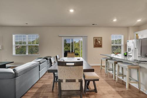 a kitchen and dining room with a long table and chairs at Beautifull house near Airport in Charlotte
