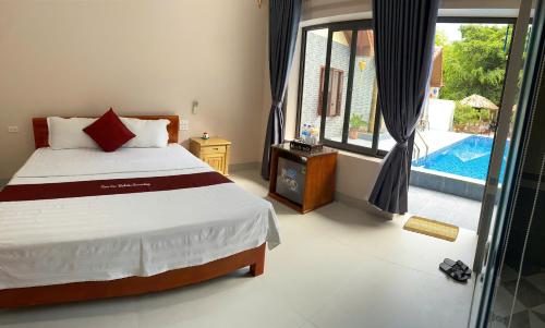 a bedroom with a bed and a view of a pool at Tam Coc Westlake Homestay in Ninh Binh