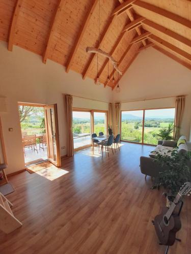 a living room with wooden floors and a vaulted ceiling at BaLOVEon Birtok in Káptalantóti