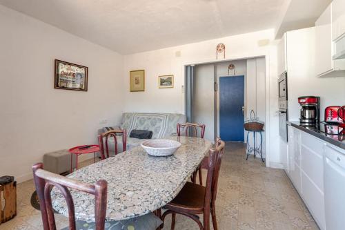 a kitchen and dining room with a table and chairs at Casa Colomer in Cadaqués