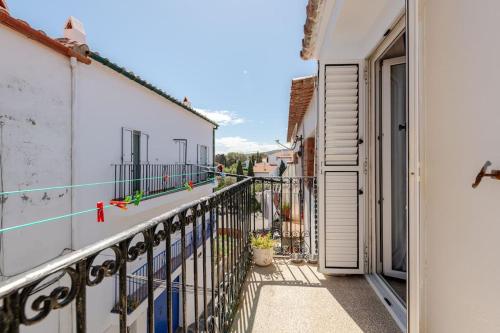 a balcony of a building with a door open at Casa Colomer in Cadaqués