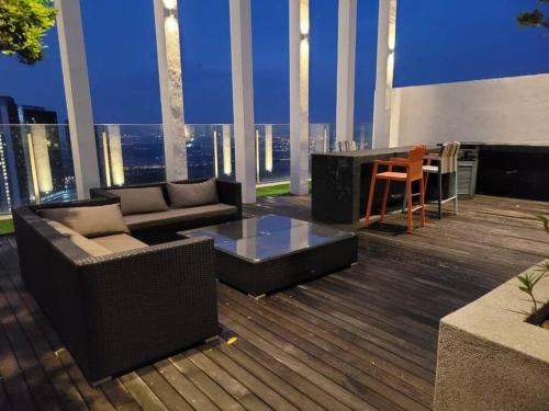 a balcony with a couch and a table on a building at GM B-1205 TWO BEDROOMS Cozy Netflix BySTAY in Iskandar Puteri