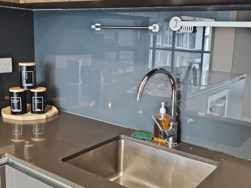 a kitchen counter with a sink and two cups at GM B-1205 TWO BEDROOMS Cozy Netflix BySTAY in Iskandar Puteri