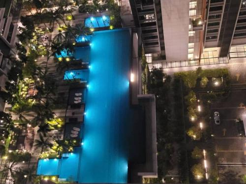 a blue fountain in the middle of a city at night at GM B-1205 TWO BEDROOMS Cozy Netflix BySTAY in Iskandar Puteri