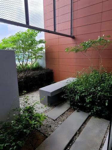 a bench sitting on the side of a building at GM B-1205 TWO BEDROOMS Cozy Netflix BySTAY in Iskandar Puteri
