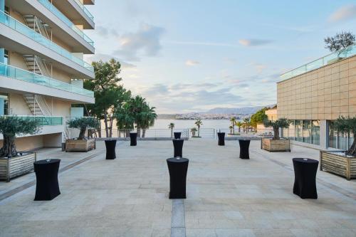 a row of black poles on a sidewalk next to a building at Le Meridien Lav Split in Podstrana