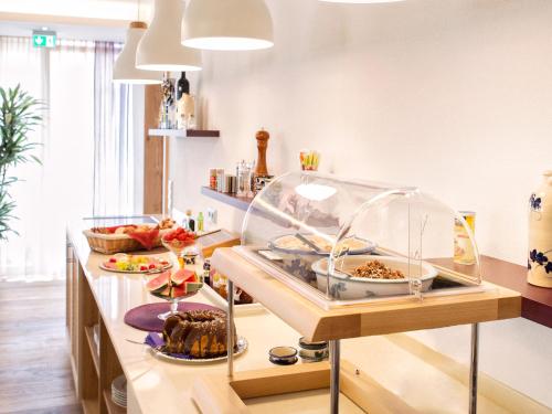 a kitchen with a buffet with food on it at Brandmayerhof in Oberding