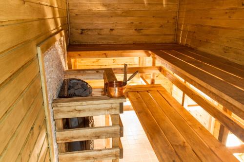an inside of a wooden sauna with a stove at Everest Kivioli Hostel in Kiviõli