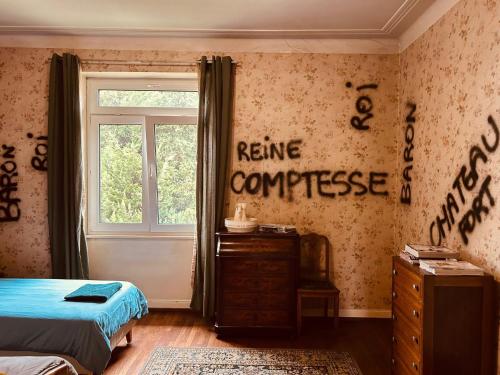 a bedroom with a bed and a window and a dresser at LA MARIEFACTURE - Comme chez le Baron in Saint-Avold