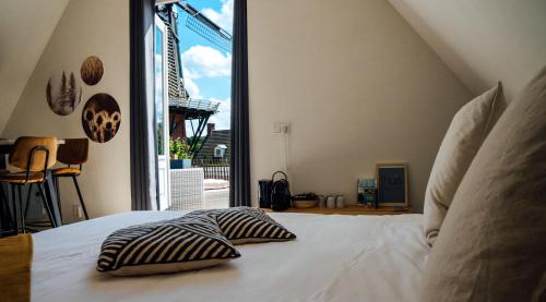 a bedroom with a bed with two pillows on it at Bij Boon in Peize