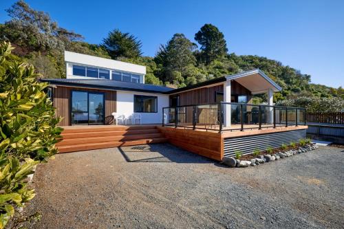 a home with a large deck and a house at Ocean Vista Modern Home Central in Kaikoura