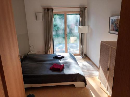a bedroom with a bed in front of a window at Gästewohnung am Schlosspark Hohenprießnitz in Hohenprießnitz