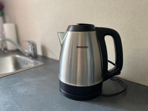 a black and silver tea kettle on a kitchen counter at Portorož Apartments Franca in Portorož