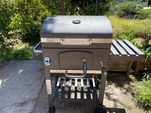a grill sitting next to a picnic table at Portorož Apartments Franca in Portorož