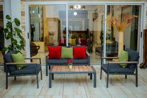 a living room with two chairs and a couch and a table at STEPHEN HOTEL in Toamasina