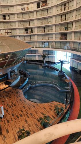 a large building with a swimming pool in front of it at Rajhansh Belliza Nest - A Luxury 2BHK Apartment in Surat