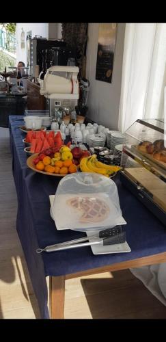 a table with a blue table cloth with fruit on it at Casa vacanze Leonardo in Peschici