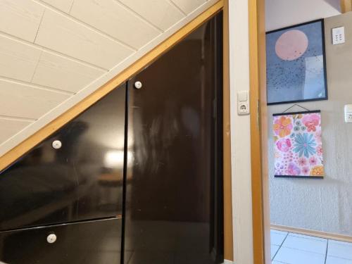 a door to a room with a black refrigerator at Ferienwohnung Freudentanz in Waldmünchen