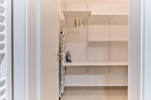 a walk in closet with white shelving at Apartmány Elite - Frištenského in Olomouc