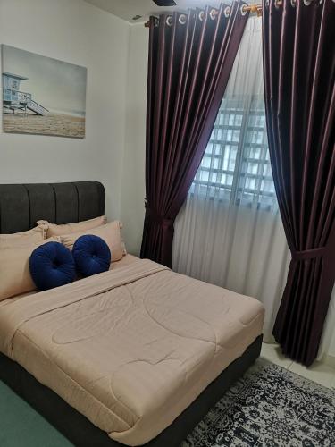 a bedroom with a bed with purple curtains and a window at Alanis Suites KLIA by Cotton Cloud in Sepang