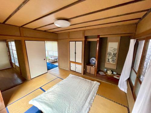 an empty room with a bed in a room at BLUE HOUSE - Traditional Home - 5min, Beach, Bus, Train in Beppu