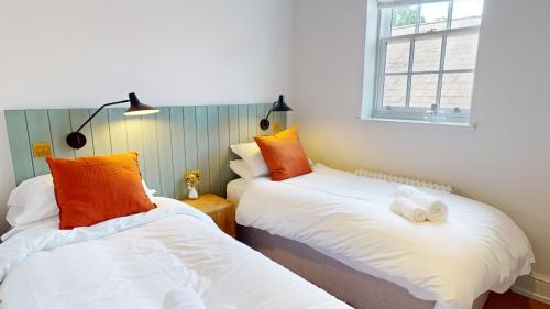two beds sitting next to each other in a room at Constantine House in Tamworth