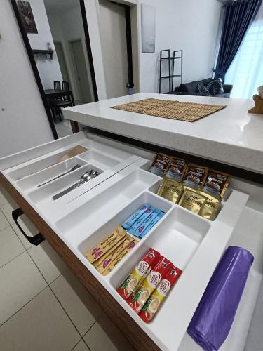 a drawer filled with lots of different types of food at Alanis Suites KLIA by Cotton Cloud in Sepang