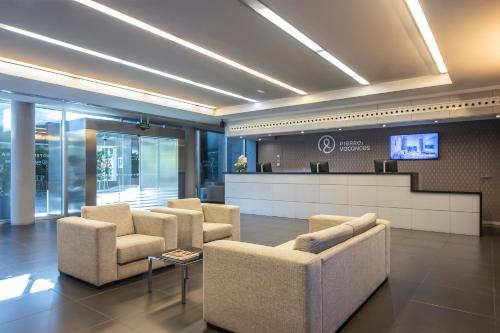 a lobby with a waiting room with chairs and a counter at Hotel Granada by Pierre & Vacances in Granada