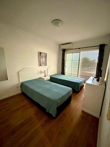 a room with two beds and a window at Lagoa Beach & Leisure in Costa de Santo André