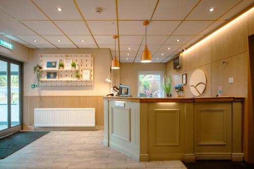 a large room with a kitchen with a counter at Highfield Hotel in Houghton le Spring