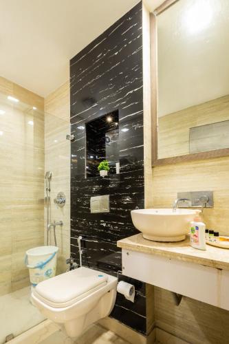 a bathroom with a sink and a toilet at Hotel Red Castle - Karol Bagh - Where luxury meets comfort in New Delhi