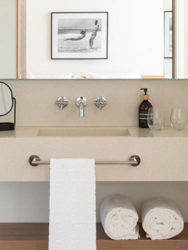 a bathroom with two towels on a shelf at Es Figueral Nou Hotel Rural & Spa - Adults Only - Over 12 in Montuiri