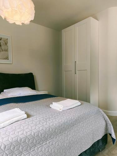 a bedroom with a bed with towels on it at Baltic Line - Nadwiślański Świt in Gdańsk