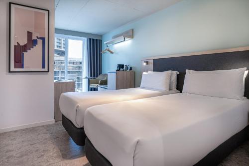 a large white bed in a hotel room at Hotel Mistral St Julian's, Affiliated by Meliá in St Julian's